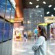 woman looking at flight schedule at airport