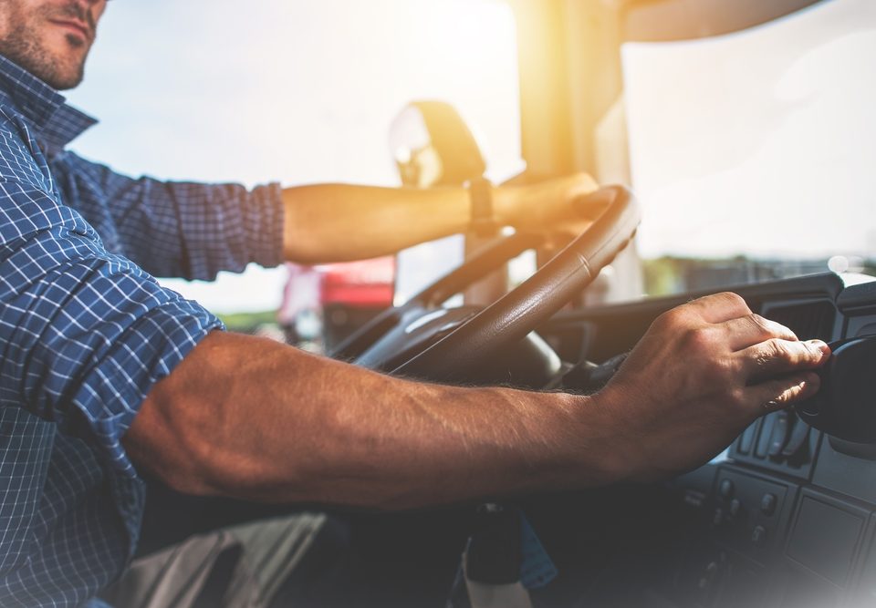 Trucker at wheel of semi truck
