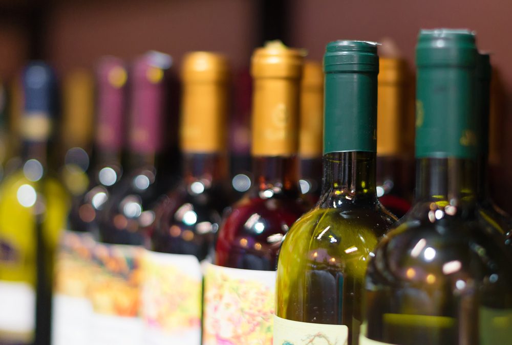 Close up photo of wine bottles on a shelf