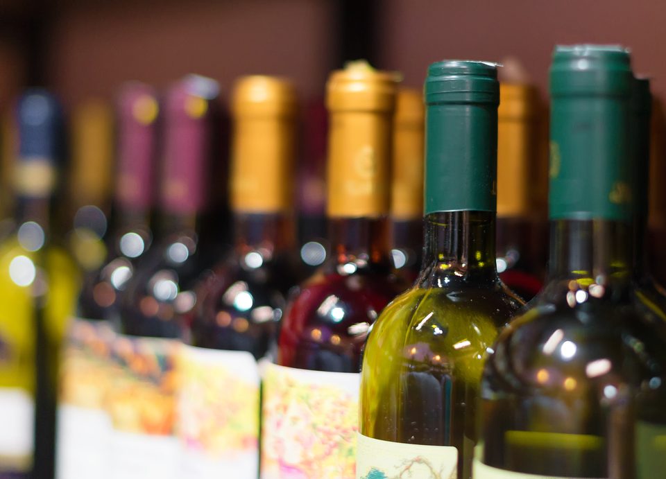 Close up photo of wine bottles on a shelf
