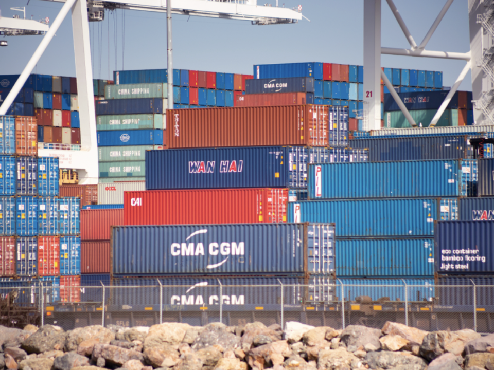 A picture of shipping carts stacked on top of each other at a port.