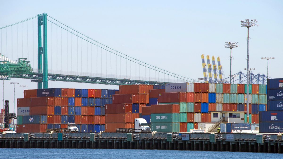 Shipping containers stacked on docks at shipping port in Los Angeles.