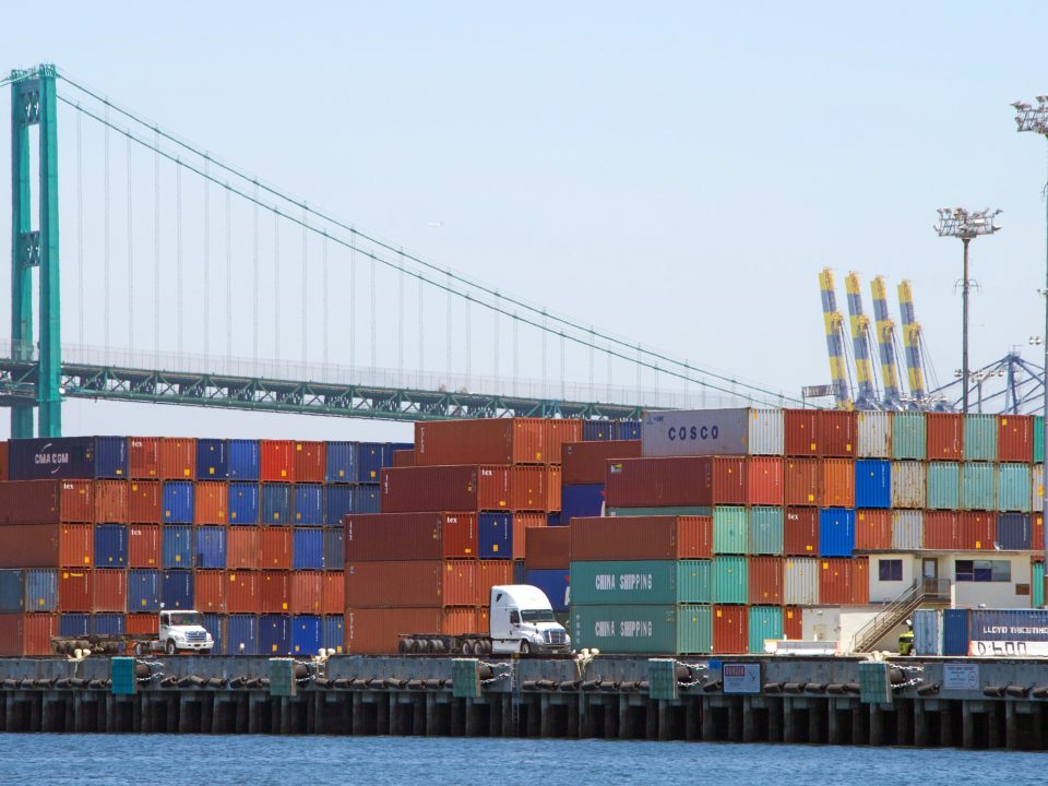 Shipping containers stacked on docks at shipping port in Los Angeles.